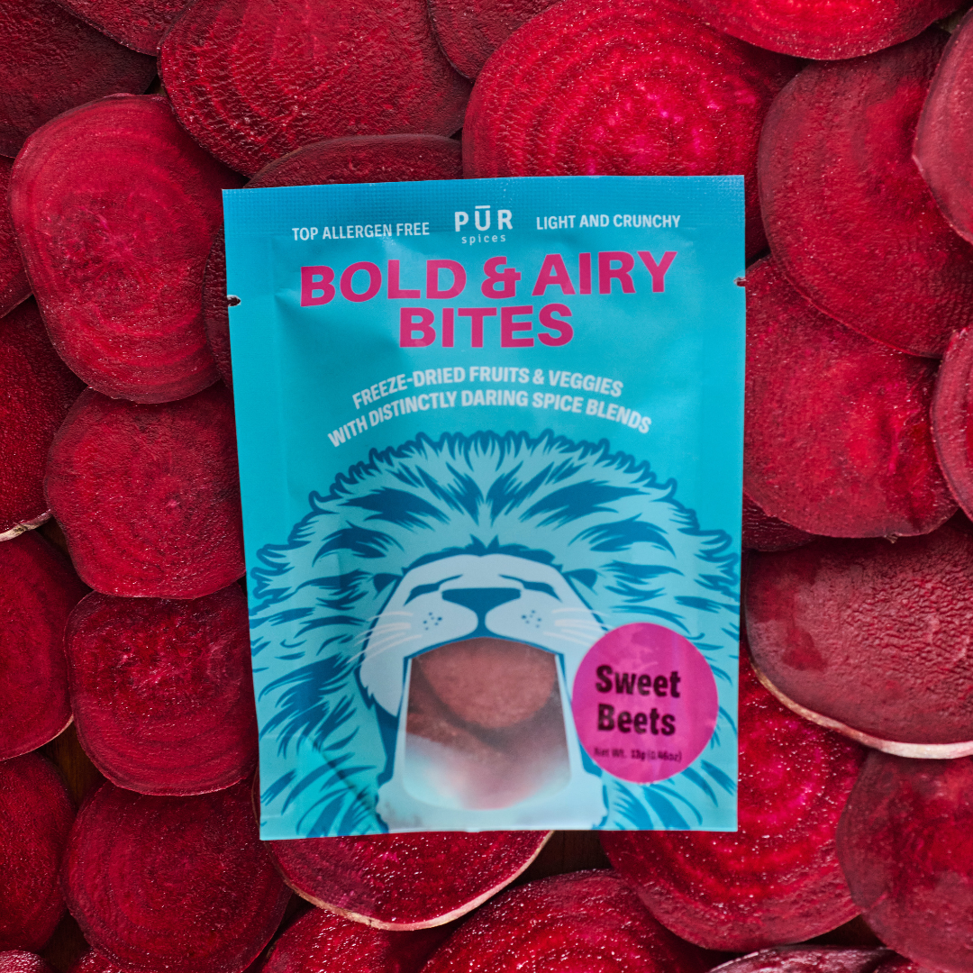 Packaging of  Sweet Beets Bold & Airy Bites on a background of sliced beets